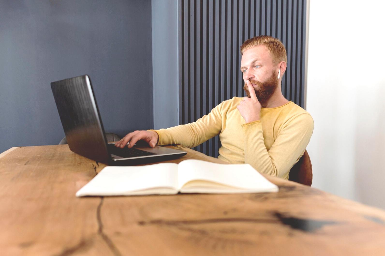 Person reviewing financial statements and taking notes